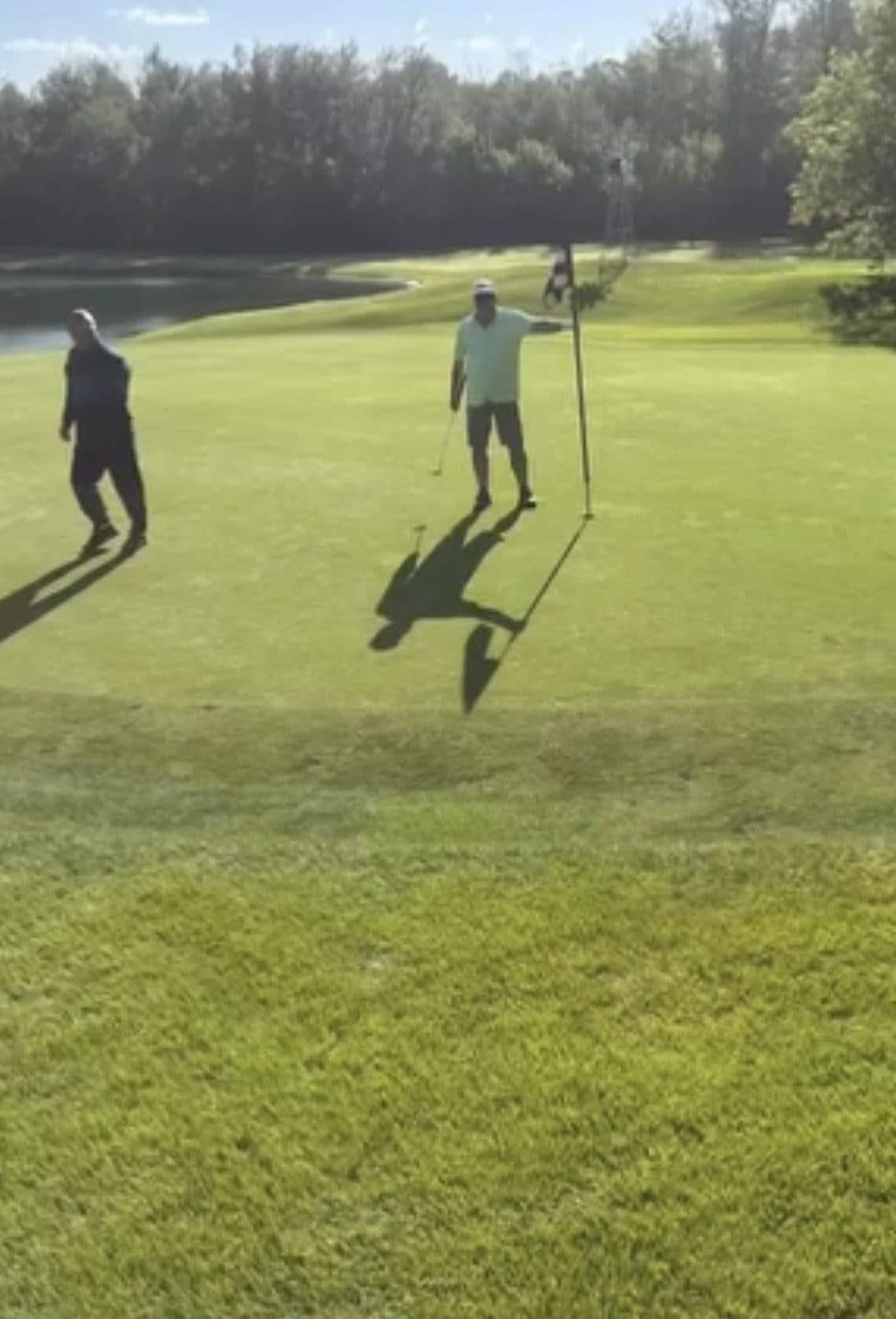 Two golfers on a green at the Drains & Drives Invitational charity tournament.